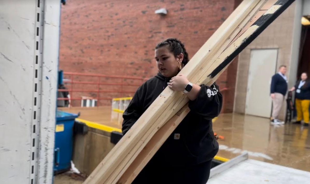 Senior Sam Bock, techie and Drama Club historian, reloads spare boards into a trailer after the Jan. 12 performance of Pippin! at Illinois State University.