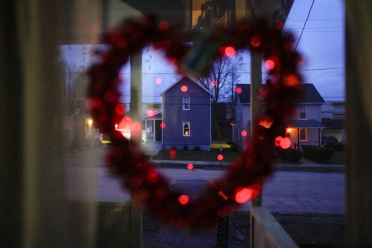 
A heart with lights hangs in the front door of Sam Chiricos home in East Palestine, Ohio, on Tuesday, Jan. 30, 2024, as a train passes behind the homes across the street. Daily life largely returned to normal for residents of East Palestine, Ohio, months after a Norfolk Southern train derailed and spilled a cocktail of hazardous chemicals that caught fire a year ago, but the worries and fears are always there.