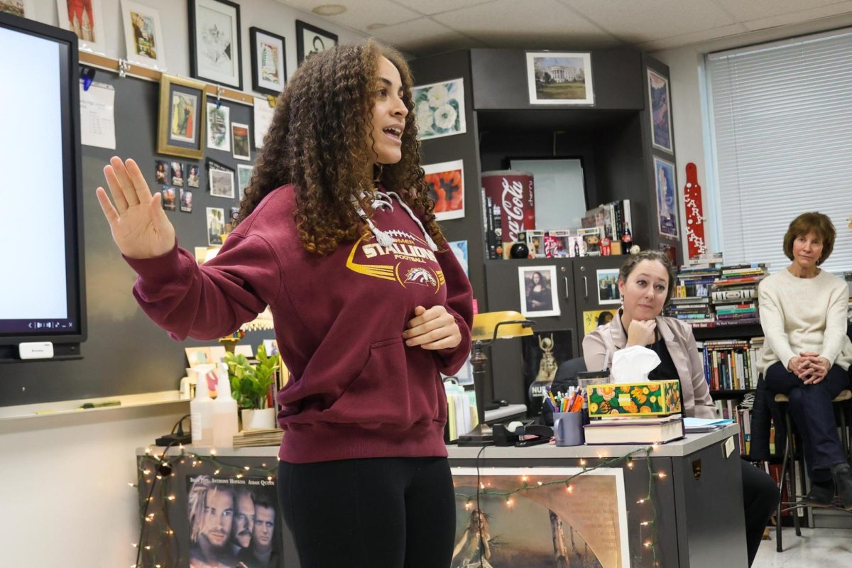 Junior Norah Washington recites her second poem during the school-wide competition in Ms. Lane's room. 