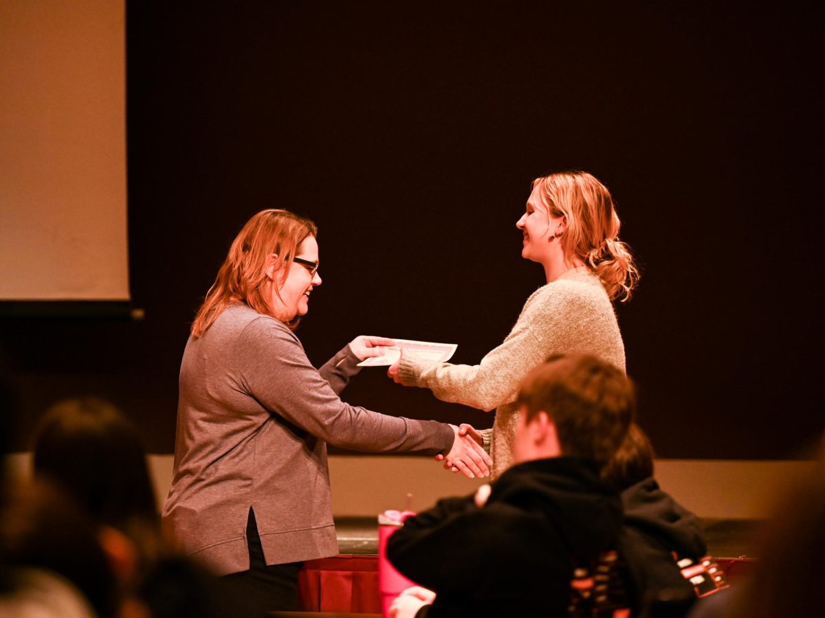 Opinion editor Sami McKenney receives an award at the SISPA Winter Conference closing session. McKenney was one of many journalism and yearbook students who were recognized for both submitted entries and on-site contest work.