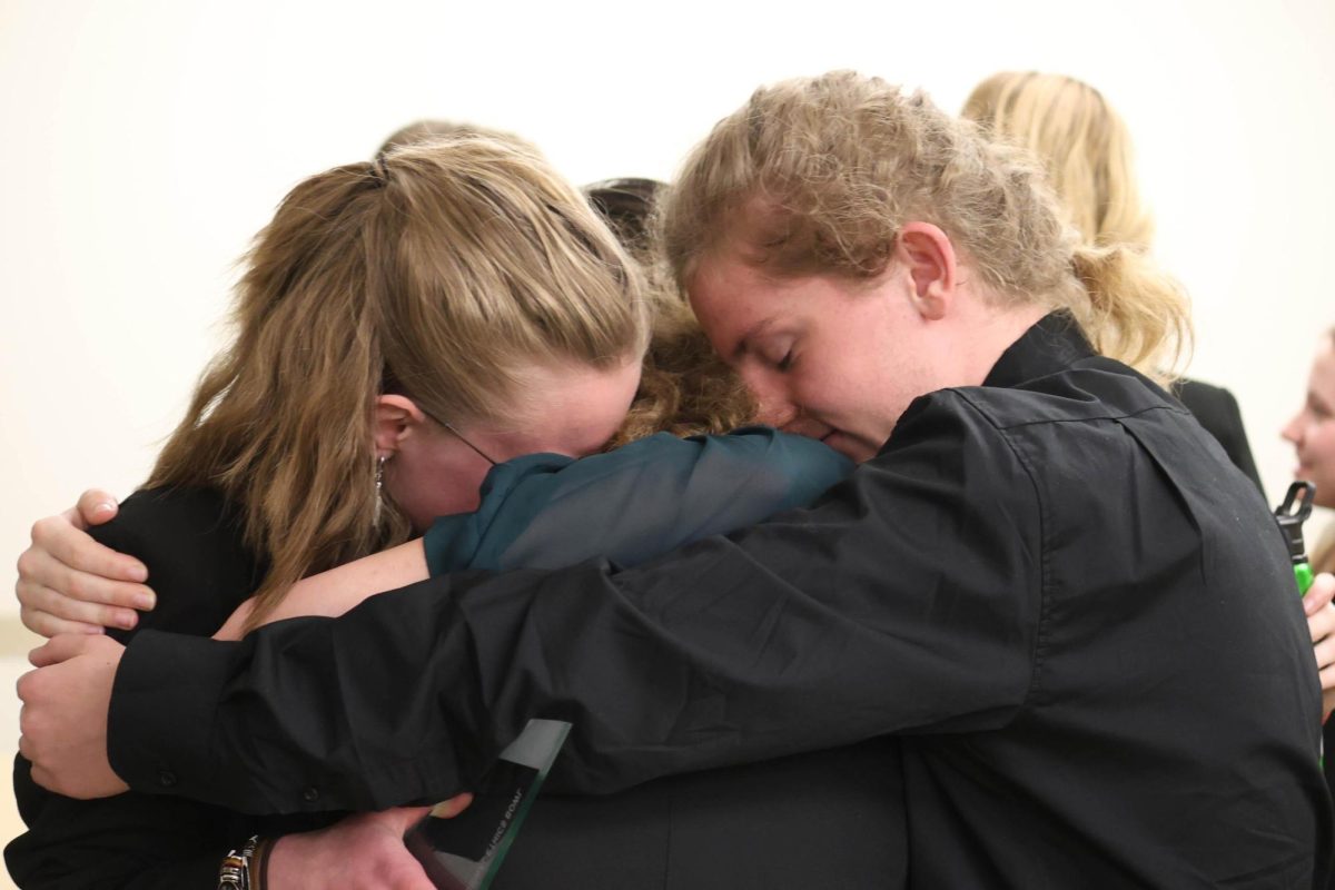 The winning team share a group hug after their victory at SIUE.