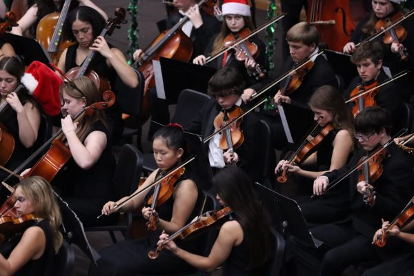 The violin section of EHS Orchestra performs at the winter concert.