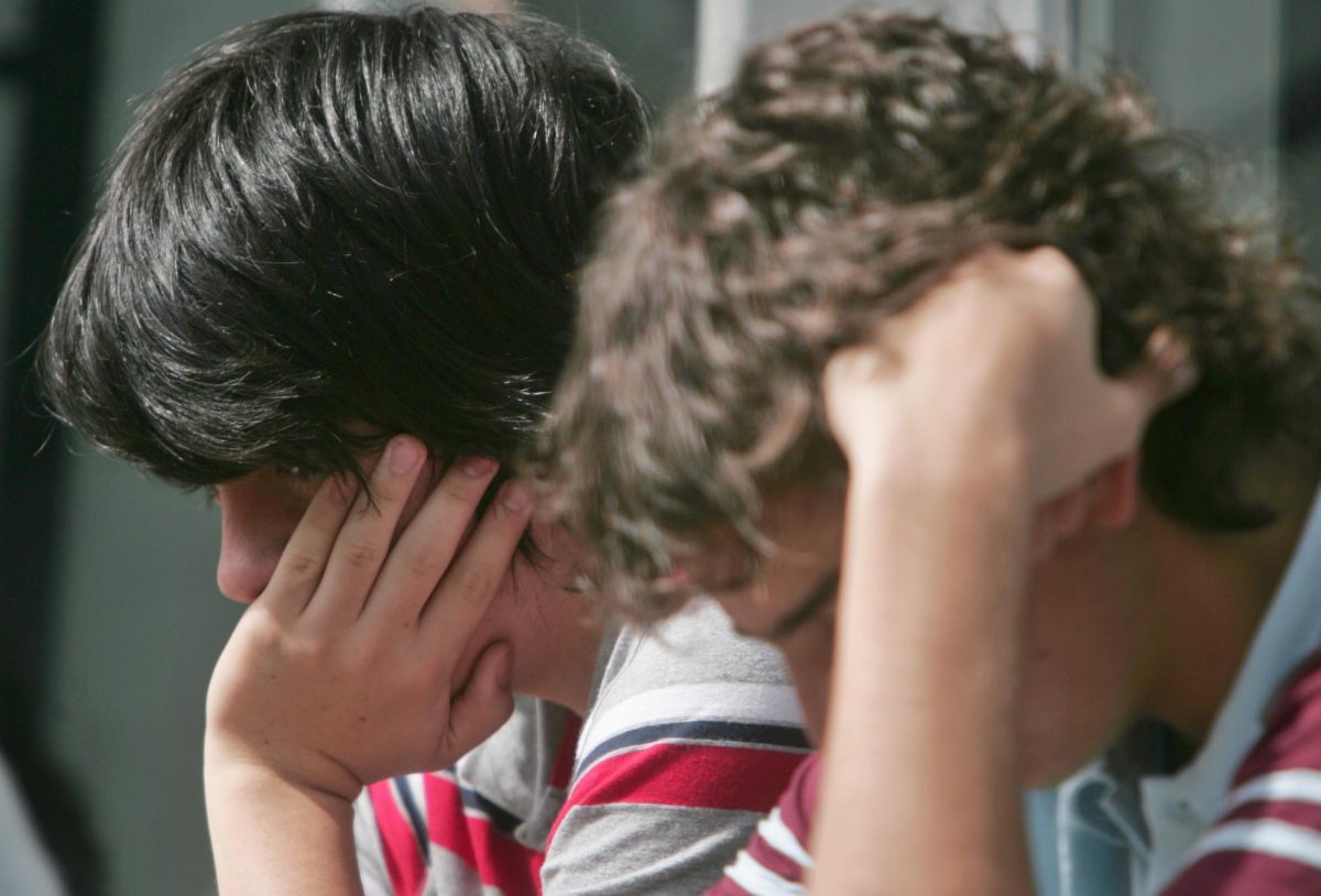 Two teenagers look stressed.