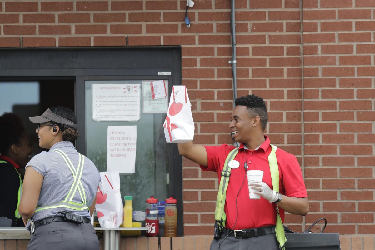 A Chick-Fil-A employee hands an order to a customer in Pembroke Pines, Florida.