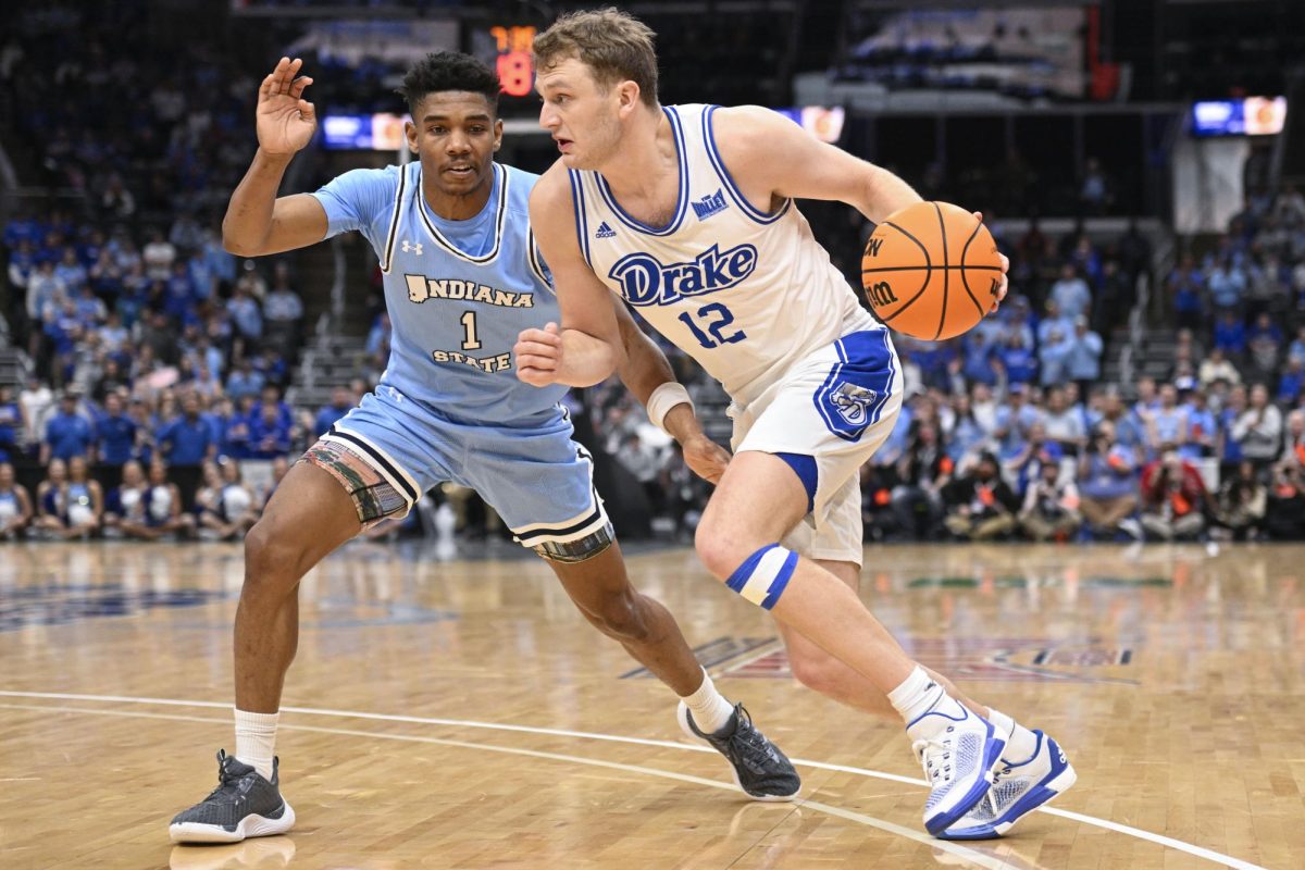 Drake's Tucker DeVries (12) drives against Indiana State's Julian Larry (1) during the second half of the championship game in the Missouri Valley Conference NCAA basketball tournament Sunday, March 10, 2024, in St. Louis.