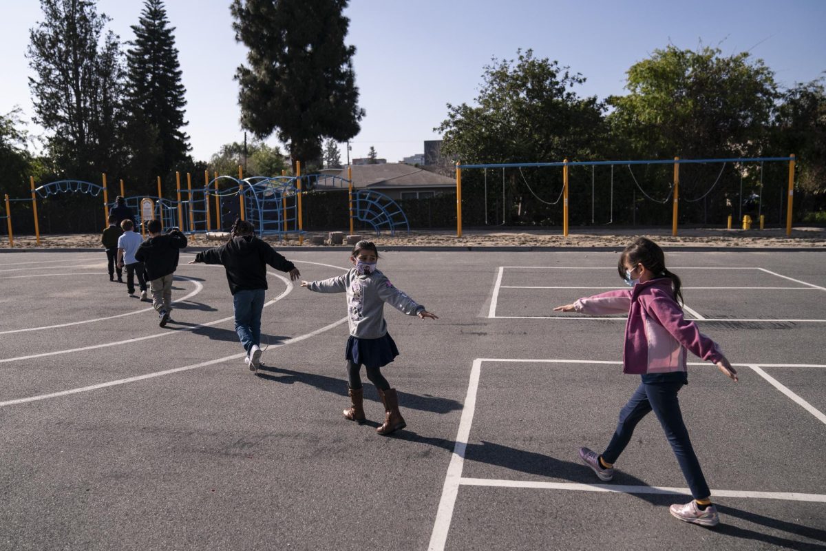 Second+grade+students+spread+their+arms+for+social+distancing+as+they+walk+to+a+playground+at+West+Orange+Elementary+School+in+Orange%2C+Calif.%2C+Thursday%2C+March+18%2C+2021.+The+school+has+been+hybrid+since+fall+last+year.+I+love+seeing+kids+being+kids%2C+said+Dana+Johnston%2C+the+schools+instructional+specialist.+Being+able+to+see+kids+have+a+little+slice+of+normal+in+our+school+day+has+been+really+great.+Its+obviously+not+quite+exactly+what+it+used+to+be%2C+but+its+one+step+closer+to+normal+for+our+kids.