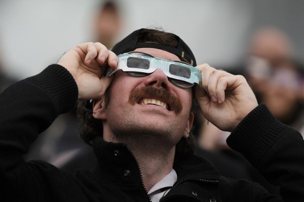 A man uses special glasses to take in the solar eclipse in Canada.