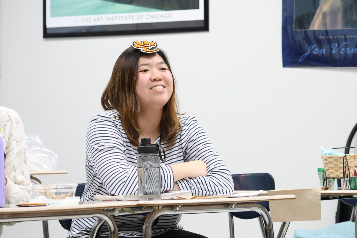 Senior Kate Huang wears her Ethics Bowl Regional E-Paw on her head after receiving it at practice on Jan. 8. 