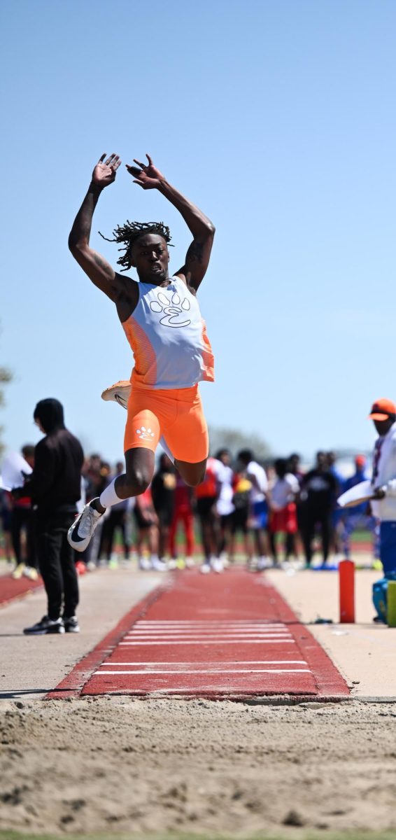Senior Malik Allen jumps at the Belleville West Invite on April 6, breaking the 42-year-old record.