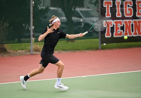 Senior Colton Hulme takes a forehand during a match against OFallon.