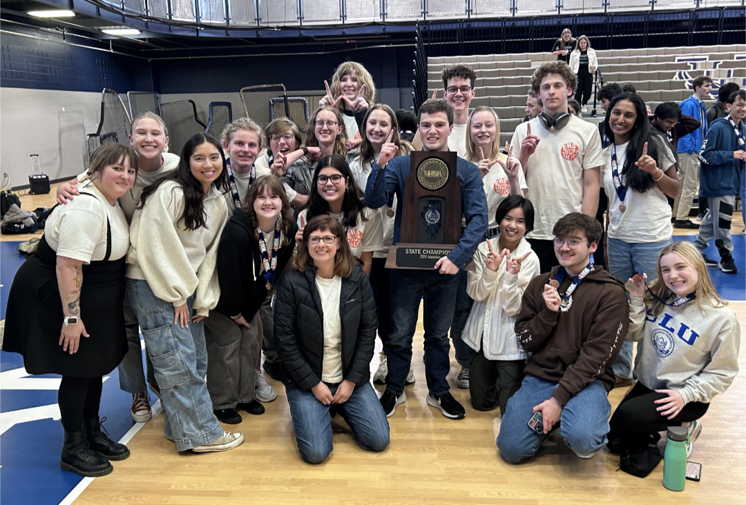 The journalism team poses with the 2024 IHSA state journalism champion trophy on April 26 after co-winning with Stevenson High School at 39 points. This was the third time in the last seven years that Edwardsville has won state for journalism.