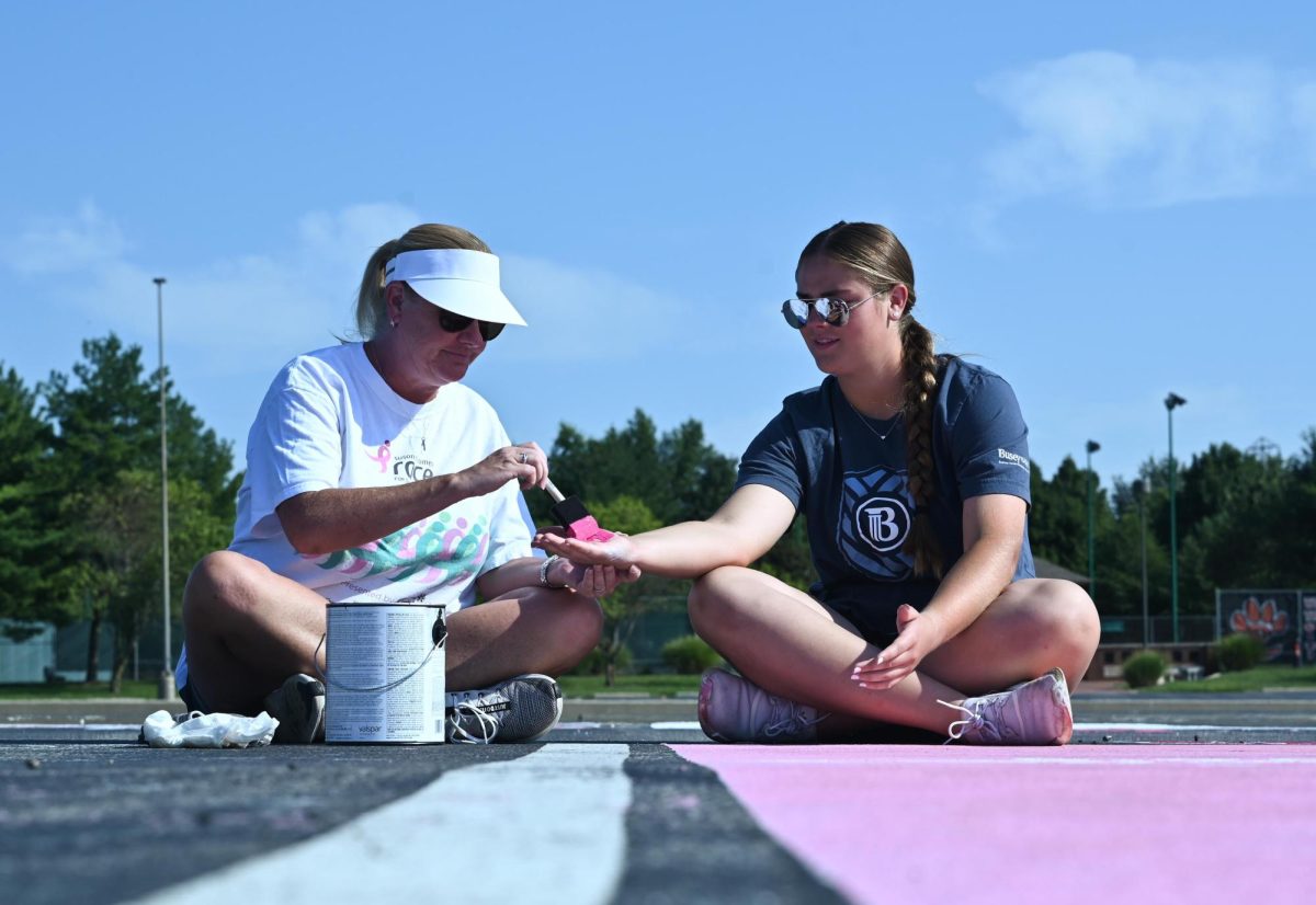 Senior Riley Nelson paints her parking spot with her mother Aug. 14.