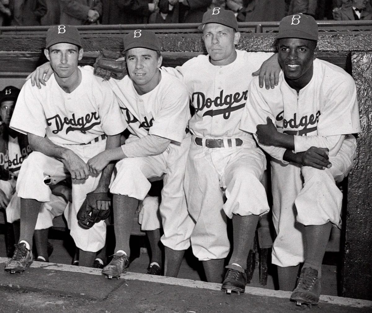 Jackie Robinson, arm-in-arm with his teammates, debuts April 15, 1947.
