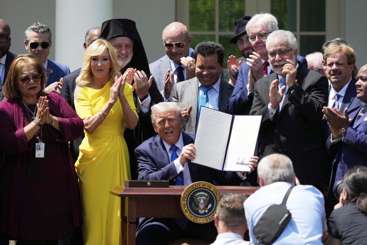 President Donald Trump, surrounded by religious leaders, holds up a signed executive order during a National Day of Prayer event in the Rose Garden of the White House, Thursday, May 1, 2025, in Washington. 


