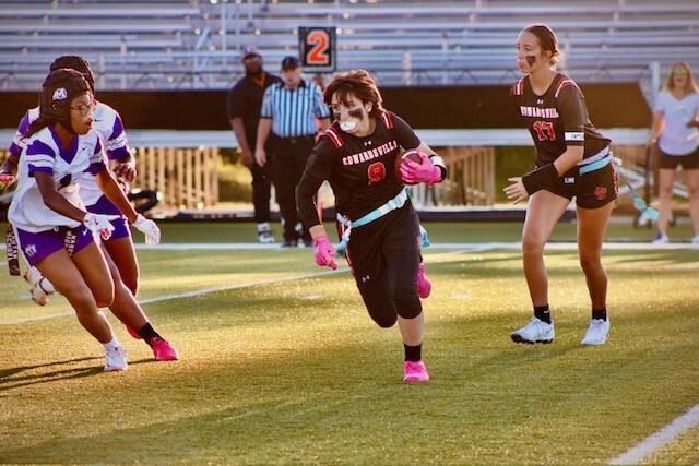 Junior Sophie Antonini carries the ball during the first-ever girls flag football game.